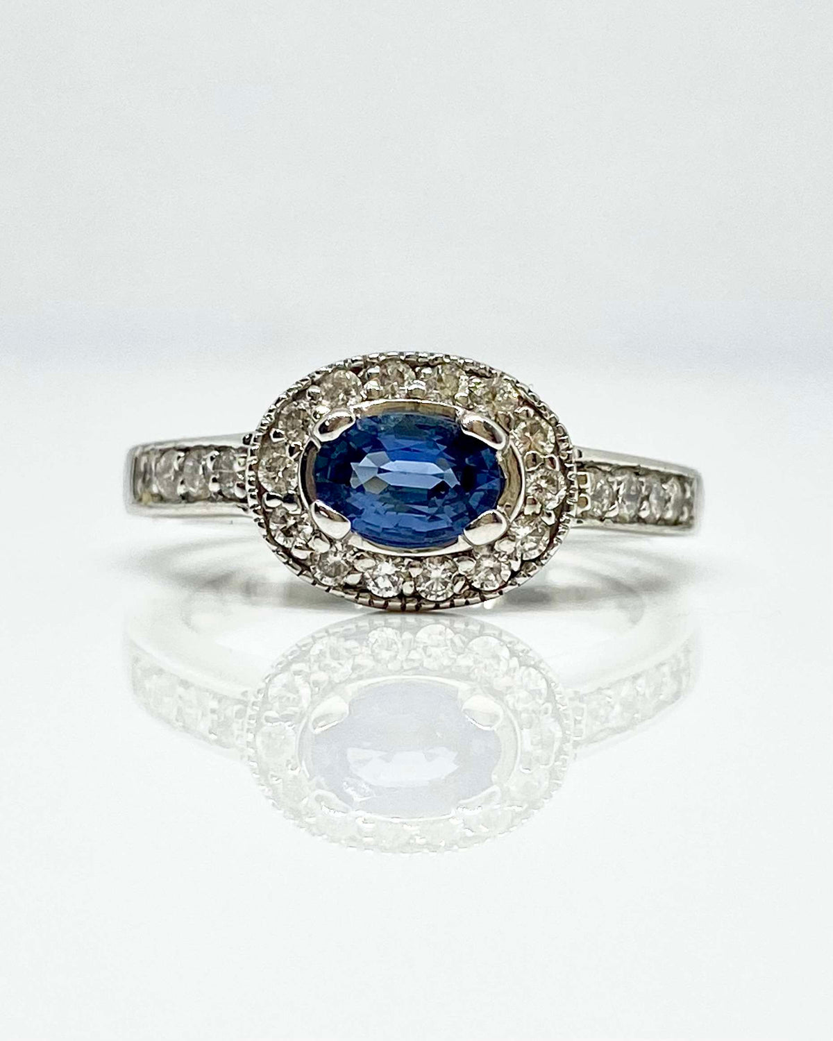14K white gold oval blue sapphire ring with diamond halo
