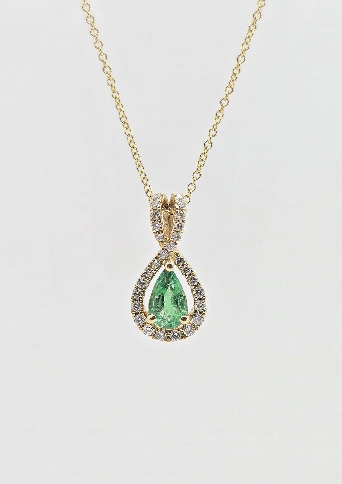 14K gold emerald necklace with diamond halo
