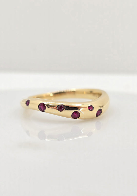 14K gold flush set ruby wave band
