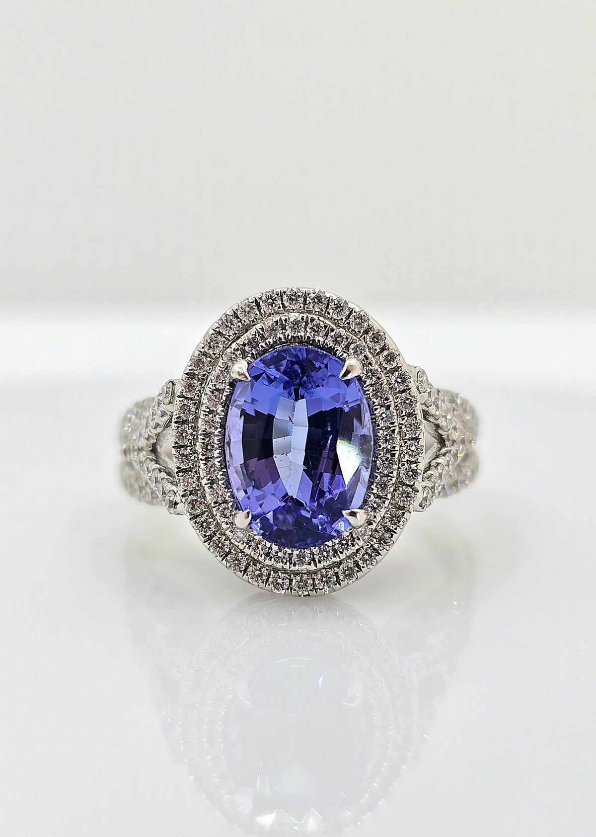 14K gold tanzanite ring with double diamond halo