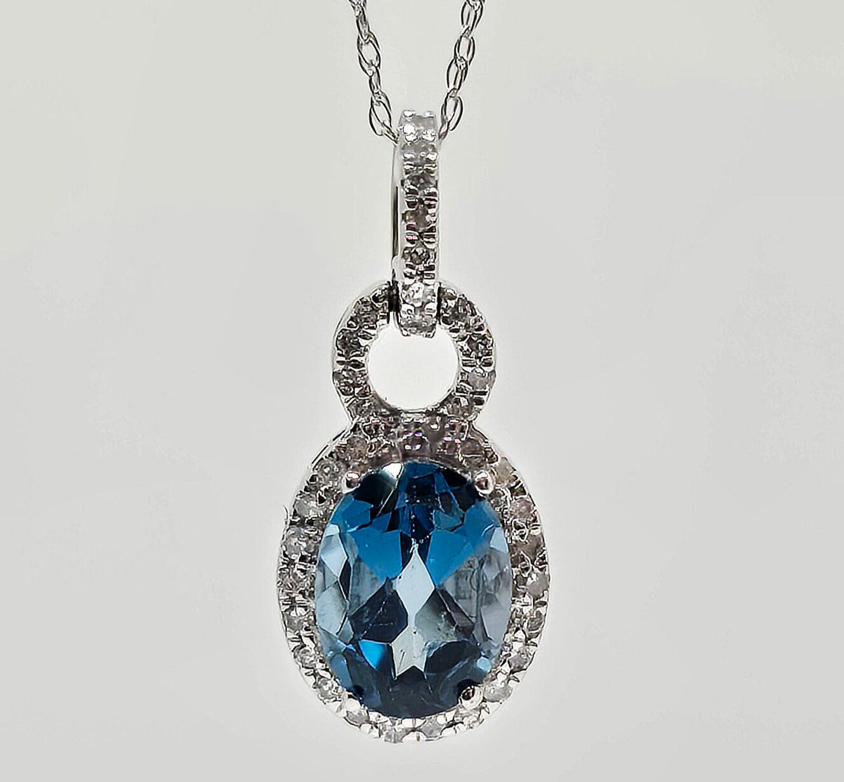 10K gold blue topaz necklace with diamond halo