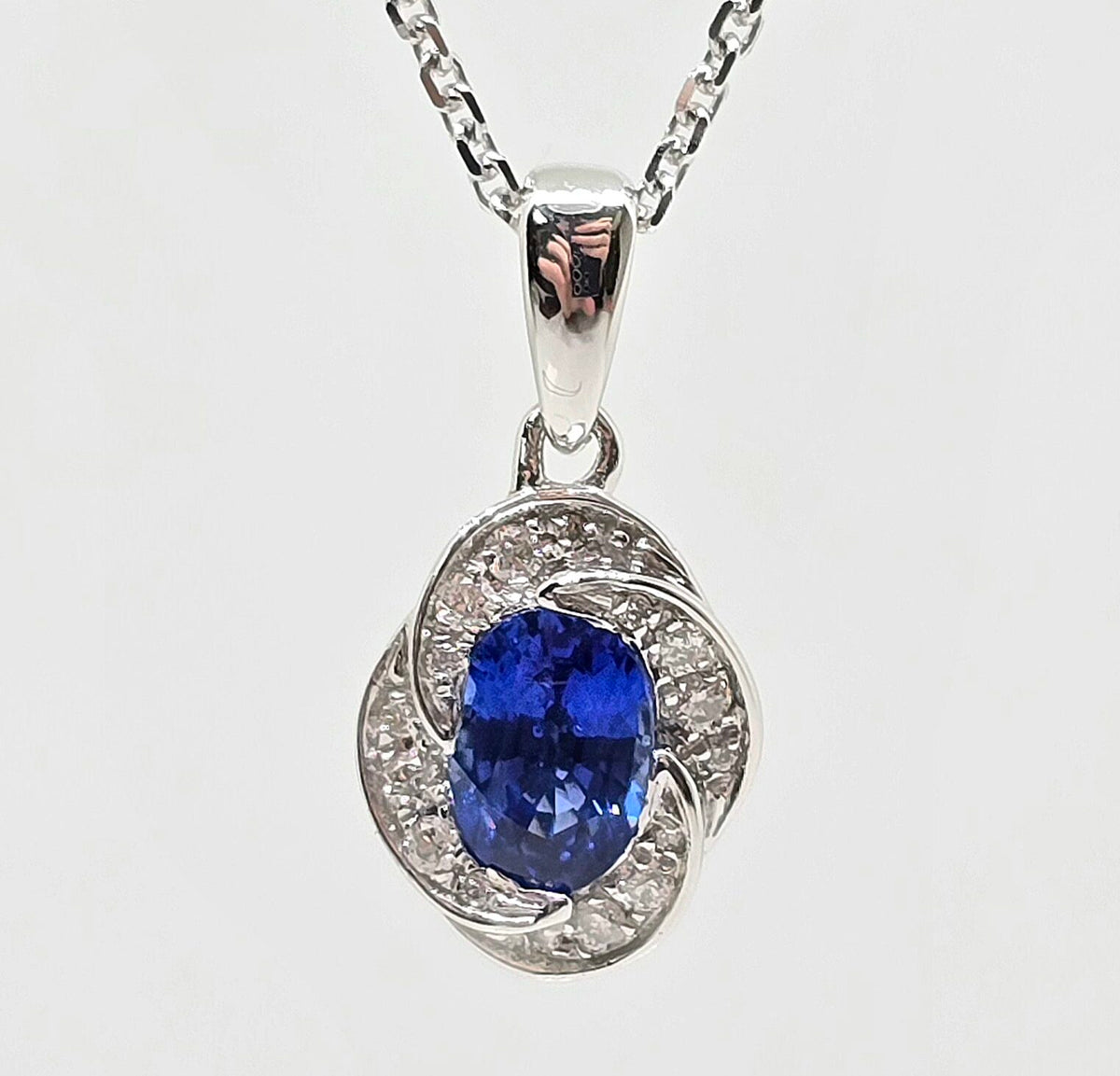 14K gold blue sapphire necklace with floral diamond halo