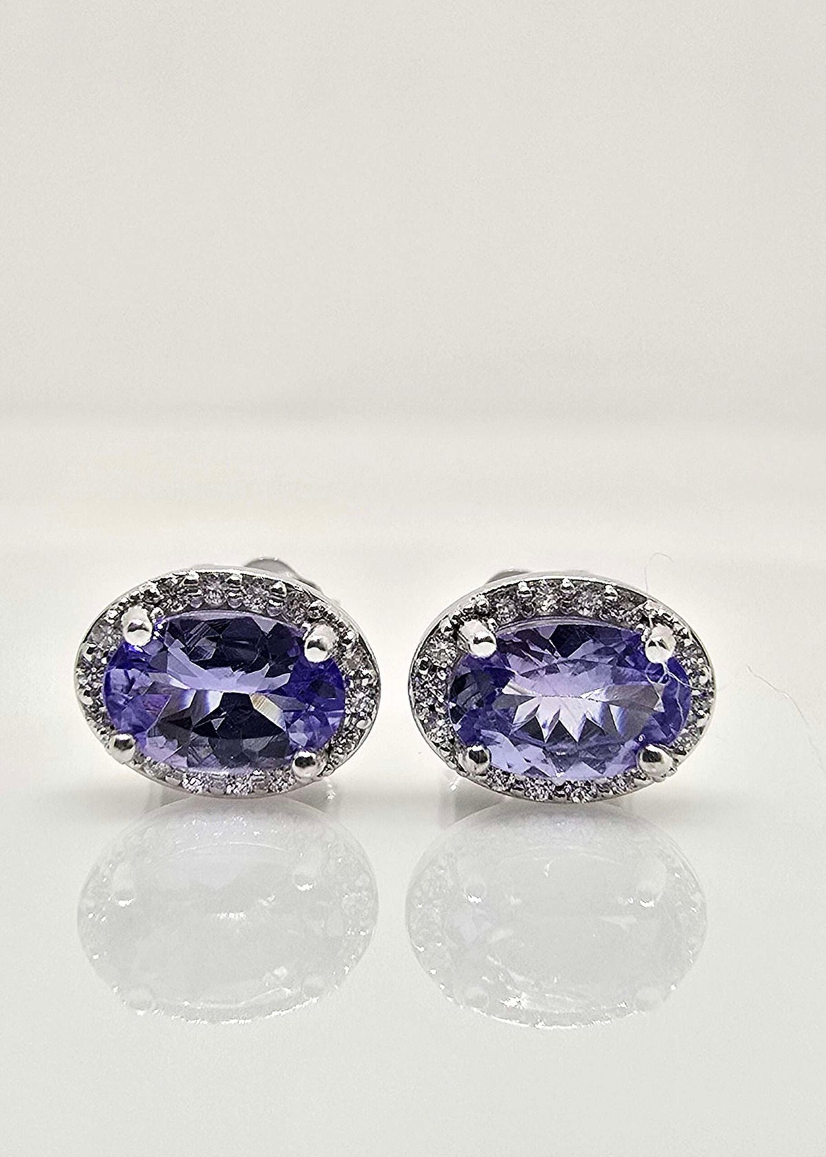 14K gold tanzanite and diamond halo earrings