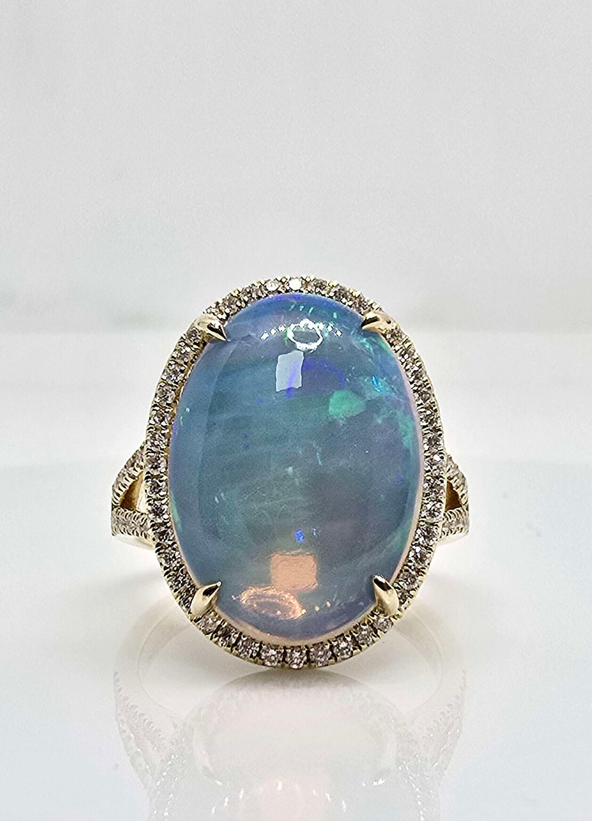 14K gold Ethiopian opal and diamond halo ring