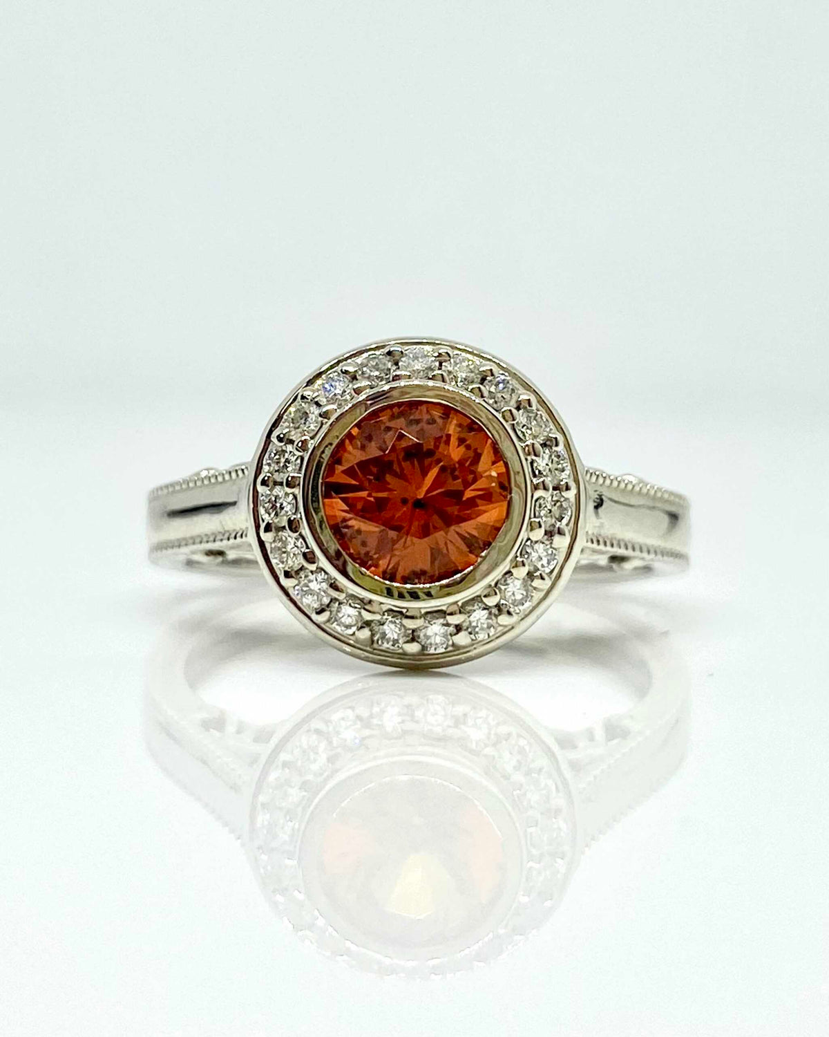14K white gold orange sapphire ring with diamond halo